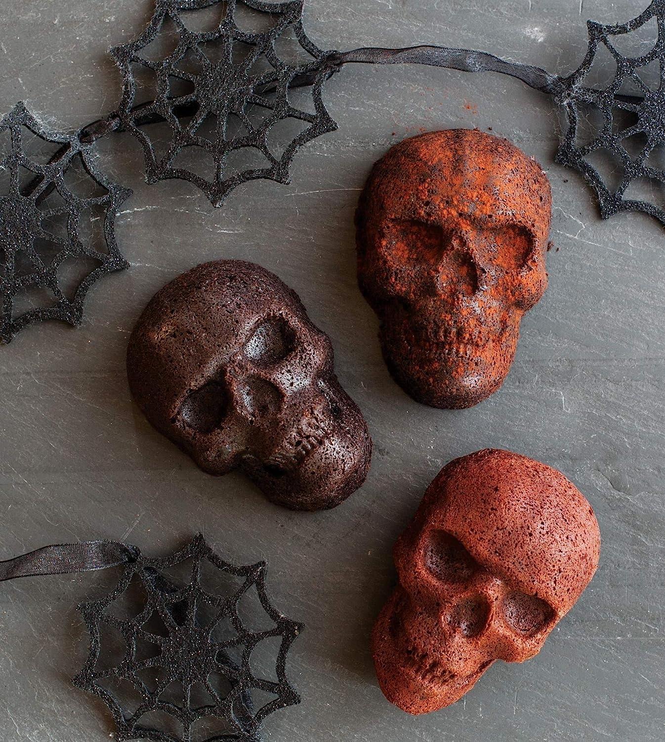 imageNordic Ware Halloween Bakeware Haunted Skull Cakelet Pan Bronze118 x 10 x 2 inches Pack of 3