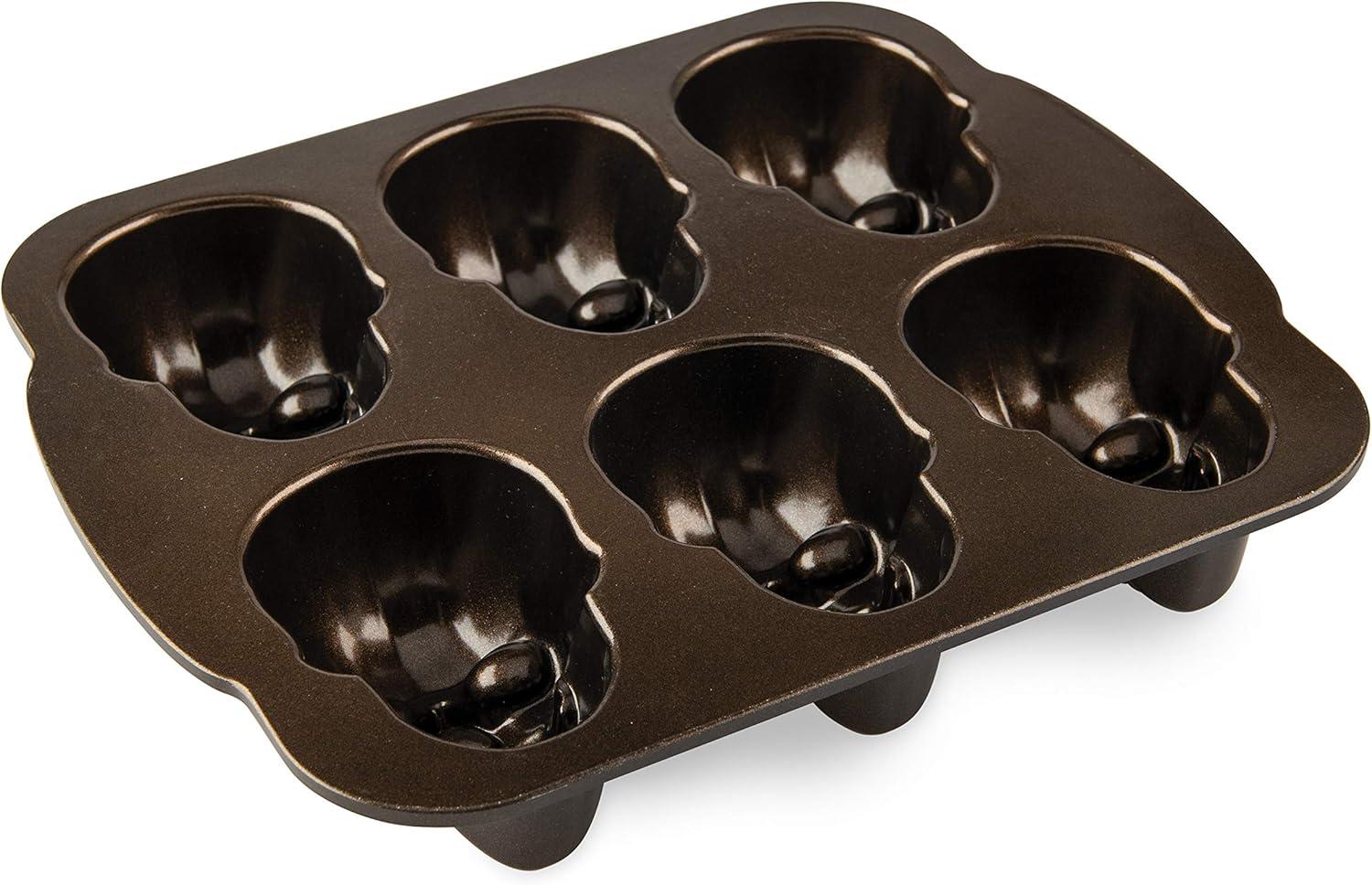 imageNordic Ware Halloween Bakeware Haunted Skull Cakelet Pan Bronze118 x 10 x 2 inches Pack of 3