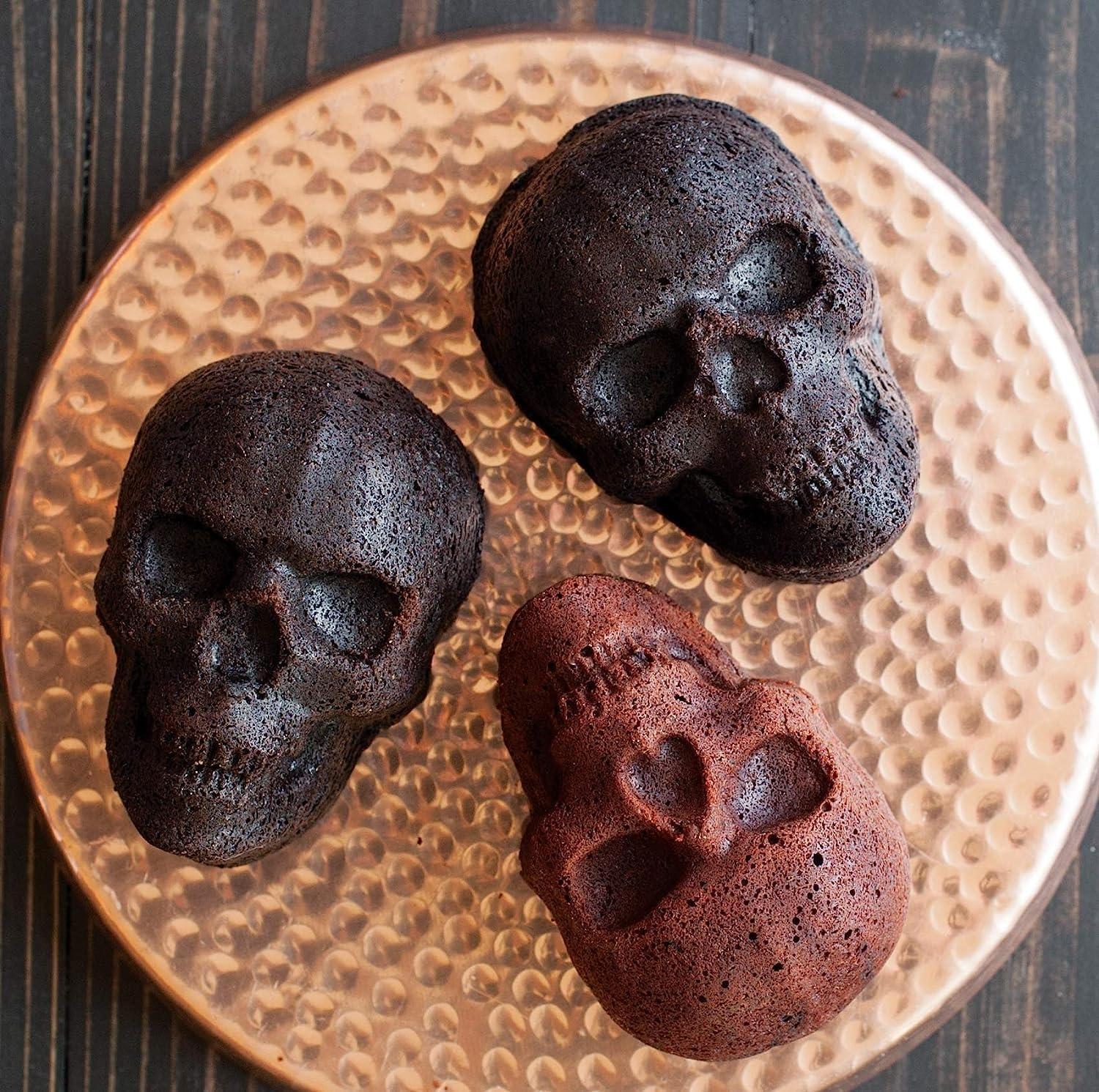 imageNordic Ware Halloween Bakeware Haunted Skull Cakelet Pan Bronze118 x 10 x 2 inches Pack of 3